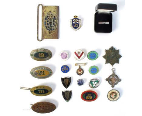 A collection of badges, of mainly Irish interest. A De Lorean Motors tie pin in presentation case; a tram- or bus-conductor's