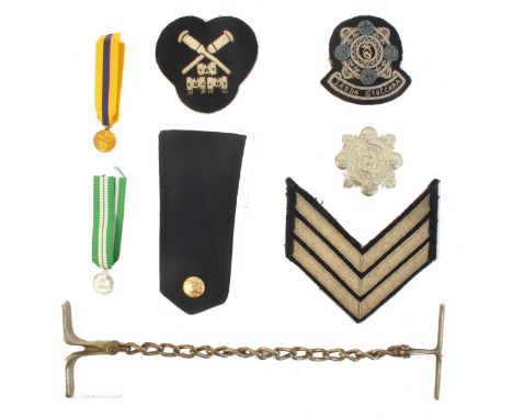 1922-1980s Garda Siochana, collection of badges, rank insignia and etc., an early 20th century steel "come along" prisoner re