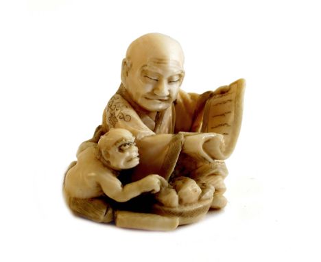 Japanese Meiji period (1868-1912) carved ivory netsuke, by Hiromitsu, of a scholar reading a scroll while an oni, or demon, s