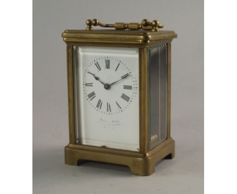 A French brass carriage clock, late 19th/20th century, of typical form, with white enamel dial and Roman numeral chapter ring