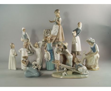 A collection of Lladro and Nao porcelain figure groups, 20th century, to include a group of a girl by a well with a cracked j