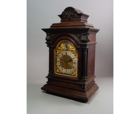 A German Walnut over mantle clock 19th century with architectural framed case,  the dial with silvered rim and Chaptering, wi