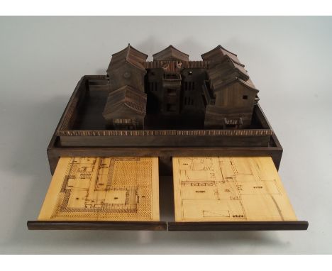 An interesting hardwood architectural model of a traditional Asian house, with courtyard and tiled wall, raised on a plinth i