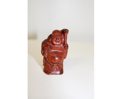 A signed box wood netsuke in the form of an Immortal