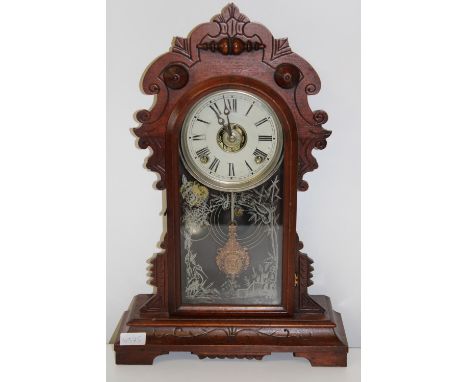 An antique American Ginger Bread striking mantel clock in GWO. Height 51cm x 36cm wide 