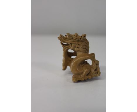 A box wood netsuke in the form of a dragon