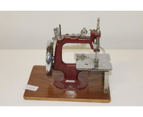 A vintage miniture table top sewing machine 