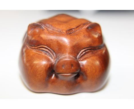 A signed box wood netsuke in the form of a pig
