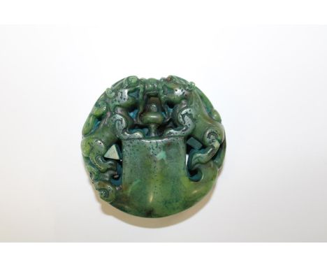 A jade amulet in the form of foo dogs