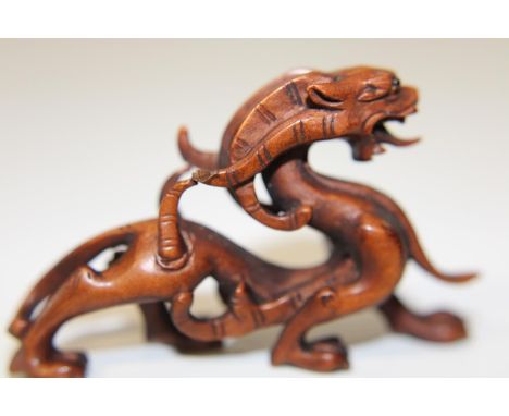 A box wood netsuke in the form of a dragon