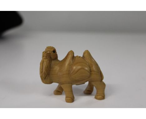 A box wood netsuke in the form of a camel