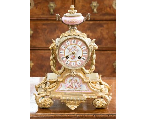 A 19th Century French gilt metal and porcelain mantle clock, the cast case with heavy swags housing Sevres type ceramic panel