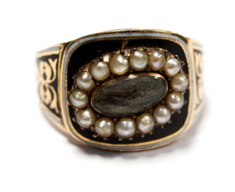 A George III mourning ring, yellow gold band, black and white enamel and seed pearl surround to a central eye-shaped glazed c