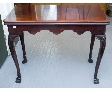 A George II mahogany folding card table, raised on cabriole legs with shell carved knees, 74cm high, 91cm wide, 46cm deep
