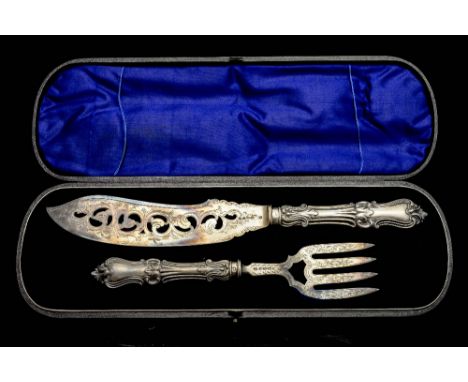 A Victorian carving set, consisting of fork and knife, each with silver handle and blade, with chased foliate scroll decorati