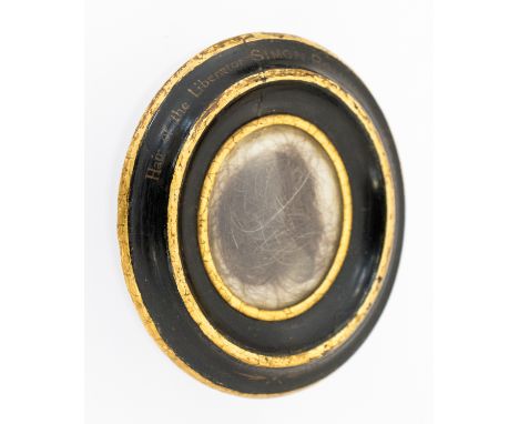 A lock of Simon Bolivar's hair, 1830, mounted in a gilt edged black papier mache oval frame, height 10cm

Note: Simon Bolivar