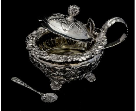 A George IV silver mustard pot, of ovoid form, with embossed foliate decoration and cast floral garland border, acanthus leaf