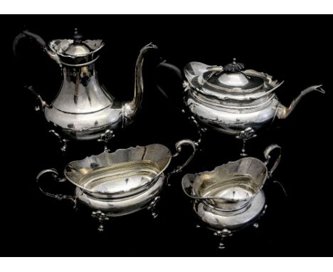 An Edwardian silver matched four piece tea service, comprising tea pot, coffee pot, sugar bowl and milk jug, each with wavy e