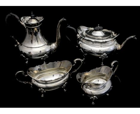 An Edwardian silver matched four piece tea service, comprising tea pot, coffee pot, sugar bowl and milk jug, each with wavy e