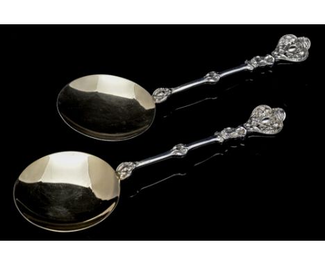 A pair of Victorian silver serving spoons, modelled in the seventeenth century Continental style, each with large spanning ci