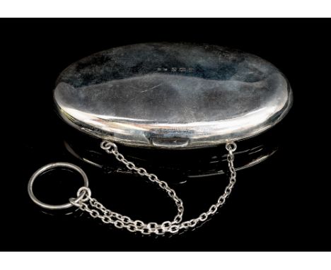 A George V silver ladies travelling purse with chain, the gilt interior opens to reveal a mirror, sovereign case, lipstick ho