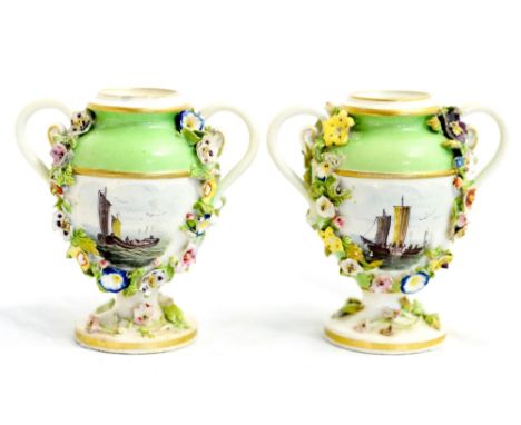 A pair of Derby Bloor vases, circa 1820, each of twin handled urn form decorated with painted seascape panels within florally