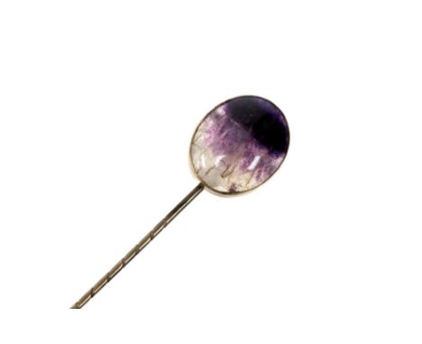 An Edwardian yellow metal stick pin, the finial set with a Blue John cabachon, approximately 1.8cm, (box) together with a pol