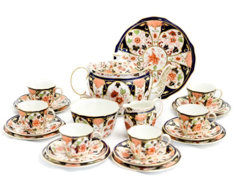 A Crown Derby imari tea service, comprising six cups and saucers, tea pot, sugar bowl, cream jug, bread and butter plate and 