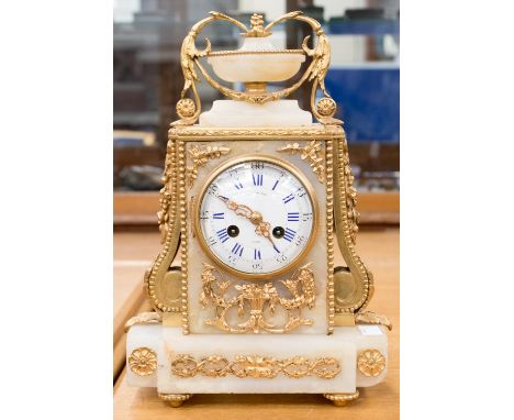 A French ormolu mounted alabaster mantle clock, Raingo Freres, Paris, 3.5 inch dial, with blue Roman numerals, flanked by scr