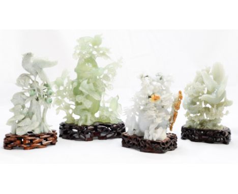 A collection of Chinese caved 'jade' ornaments, reticulated foliate designs, on hardwood bases (9)