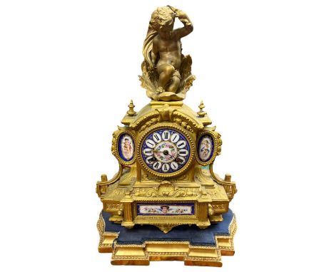 A Late 19th Century French Gilt Spelter and Porcelain Mounted Figural Clock.The Arched Case Summounted by a Cherub in a Shell