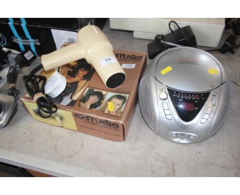 A Boots Studio hair dryer together with a portable radio and CD player 