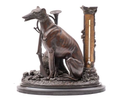 A late 19th/early 20th century bronzed metal desk thermometer: in the form of a dog seated by tree stump with gun and horn re