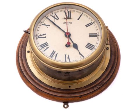 A circular brass 8-day bulkhead clock by Smiths:, signed to dial as per title with Roman numerals and red sweep seconds hand,