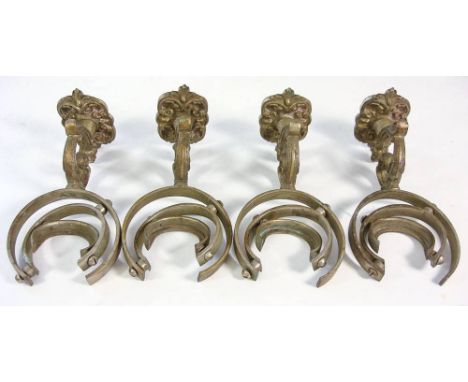A set of four early 20th century cabin brass gimbled candle wall light fittings,: each on a cast scroll arm with scroll cast 
