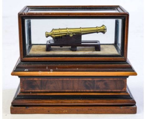 A cased mahogany and brass scale model cannon:, the brass five stage barrel on a mahogany mount in a glazed inlaid mahogany c