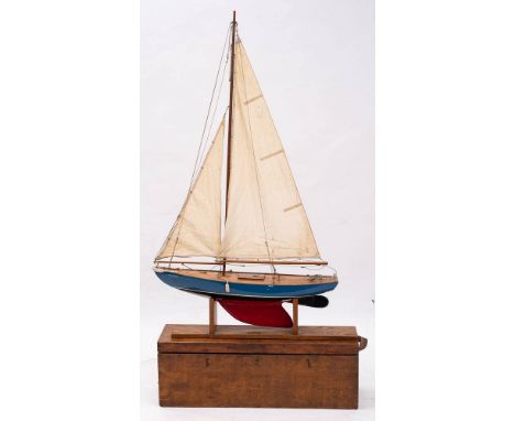 A scale model pond yacht 'Caledonian': fully rigged over planked deck with fittings, the hull painted blue above the water li