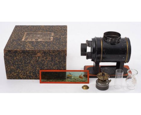 Ernst Plank (Germany) A 'Latern Magica' tinplate magic lantern: the black Russian lacquer body with chimney on a wooden base,