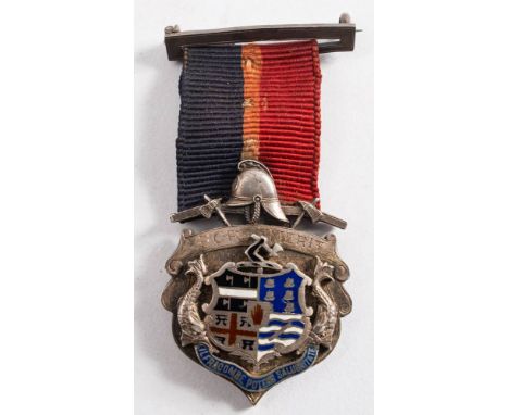 The Great Fire of Ilfracombe, 1896, silver and enamel presentation medal to J Gumm: composed of the town crest surmounted by 