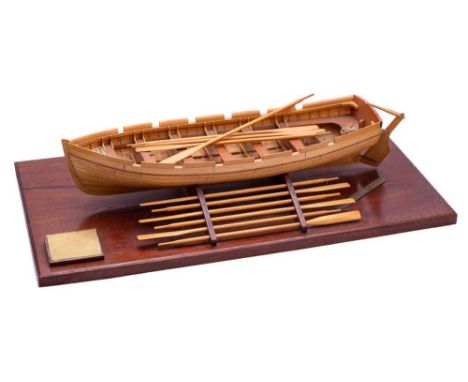 A 3/4 inch scale model of a Brig-of-war's longboat by R Phillips: of plank and pin construction with sets of oars in an oak m