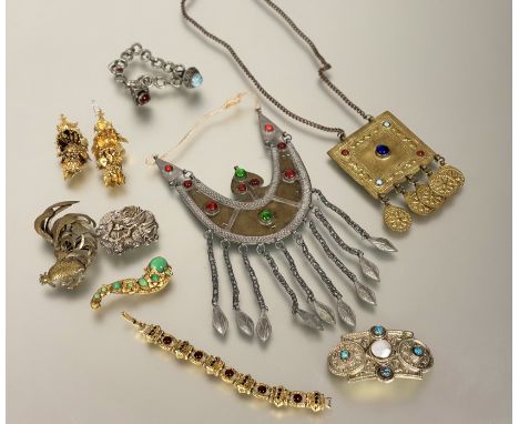 A collection of continental and eastern jewellery to include; a yellow metal cockeral brooch: h. x 9cm, two metal glass beed 