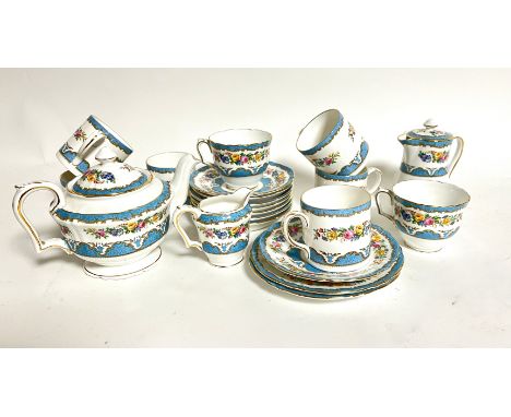 A part Crown Staffordshire tea service with floral pattern in blue border with gilt detailing to the handle and top including