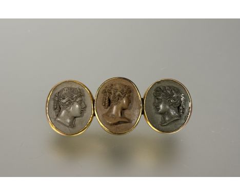 A early 19thc yellow metal Grand Tour brooch set three Italian oval lava cameo portrait panels: l. x 5.5cm 14g&nbsp;