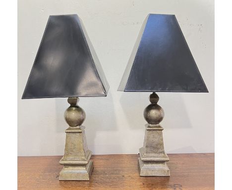 A pair of plaster ball and obelisk shaped lamps with black triangular shaped shades with internal silver finish (total h. x 8