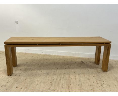 A oak console table with floating top on square supports: h. x 78cm x L. x 235cm w. x 58cm