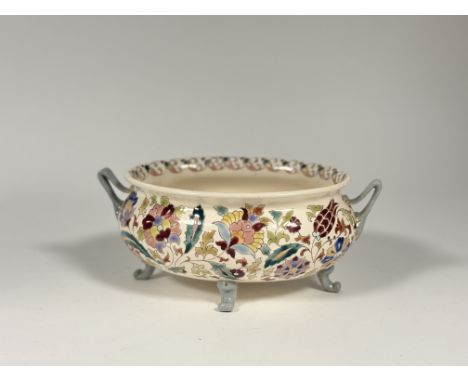 A Hungarian Zsolnay Pecs style twin handled fruit dish raised on four scroll feet. (h- 12cm l -29cm) (marked verso)&nbsp;