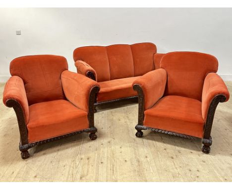 A 1920 carved walnut framed sofa with matching easy chairs in depp coral velvet ( with full set of calico down seat pads) sof