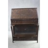 A Globe-Wernicke oak bureau with bookcase section to the base with maker's label. H.112 W.87 D.11