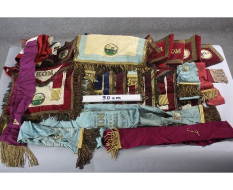 A large collection of approximately thirty pieces of Masonic regalia. Including tunics, sashes, epaulettes and other items. (