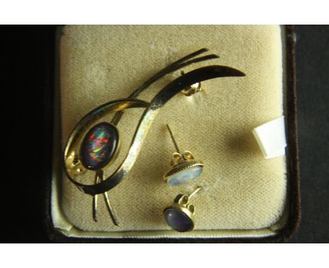 A boxed vintage Australian black opal doublet brooch and matching earrings. The stud earrings have butterfly backs. 